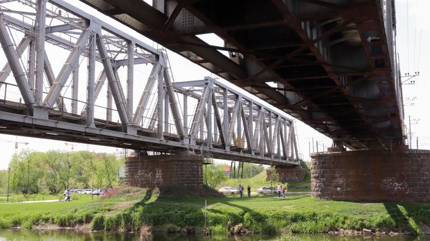 Railway bridge over the river, bottom view in the summer