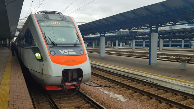 The high-speed passenger electric train Hyundai Rotem Tarpan HRCS2 Intercity stands on the platform of the central railway station in Kiev. Ukrainian railways. Ukraine, Kiev - June 09, 2021