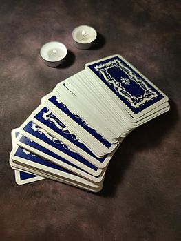 tarot cards and candles on dark vintage background.