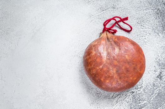 Sobrassada cured meat sausage from ground pork, paprika and spices. White background. Top view. Copy space.