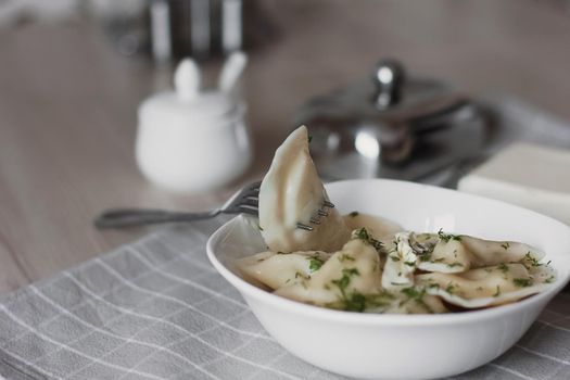 Dumplings, filled with potatoes and served with butter and fennel. Varenyky, vareniki, pierogi, pyrohy. Dumplings with filling