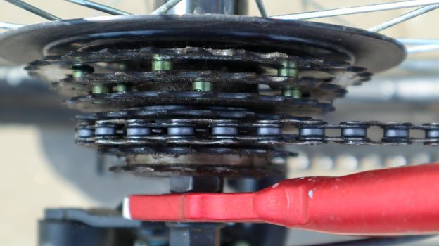 Close-up of a rear set of gear shifting sprockets on the rear wheel of a modern mountain bike with chain. Bicycle repair