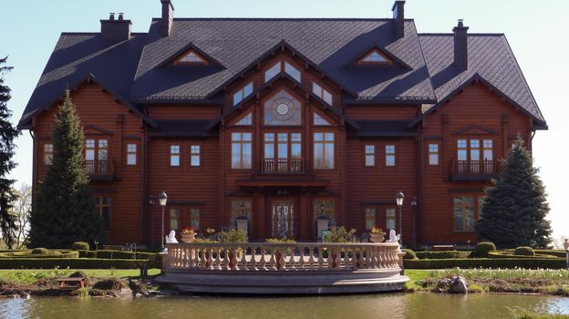 Luxurious residence of the former President of Ukraine Viktor Yanukovych on the shore of the pond. Luxurious house Honka in Mezhyhirya. Ukraine, Novye Petrovtsi - June 05, 2021