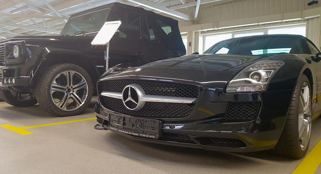 Mercedes Benz SLS amg Roadster, 2012. Double luxury supercar in the back of a coupe. The sports car is equipped with a 6.2 L V8 M159 engine. Ukraine, Kiev - June 09, 2021