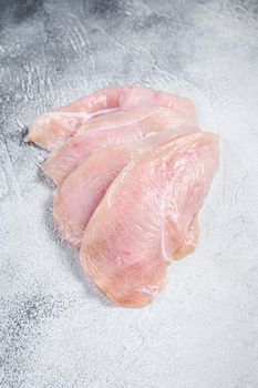 Raw sliced chicken breast fillet steaks. White background. Top view.