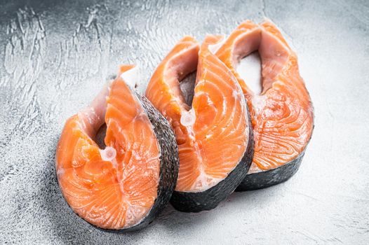 Salmon or trout steaks, raw fish prepared for cooking. White background. Top view.