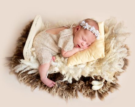 Sweet newborn baby on wool rug, sleeping in peace