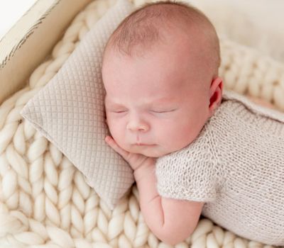 cute newborn baby girl sleeping in a little bed