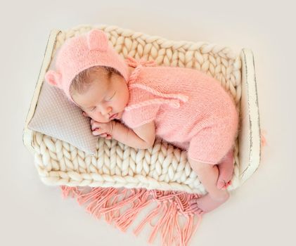 cute newborn baby girl sleeping in a little bed