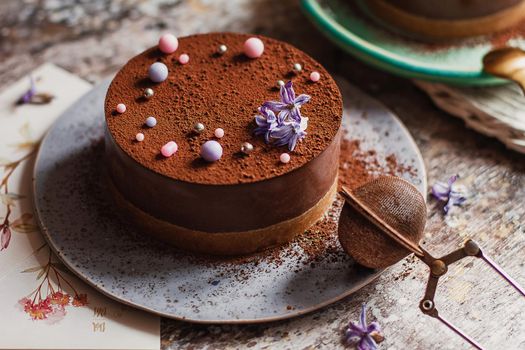 Plate with slice of tasty homemade chocolate cake on table.