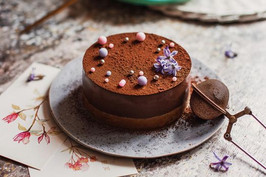 Plate with slice of tasty homemade chocolate cake on table.