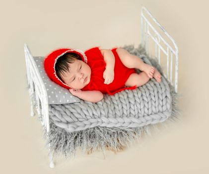 cute newborn baby girl sleeping in a little bed