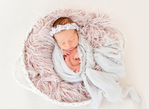 newborn baby girl sleeping sweetly in the basket