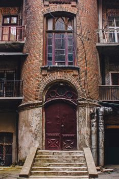 Old wooden weathered door in ancient town architecture