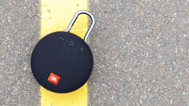 Waterproof round Bluetooth-speakers JBL Clip 3 in black color with a carabiner. Digital music and audio concept. Mini, suitable for travel. Ukraine, Kiev - June 09, 2021
