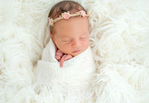 newborn baby girl sleeping sweetly in the basket