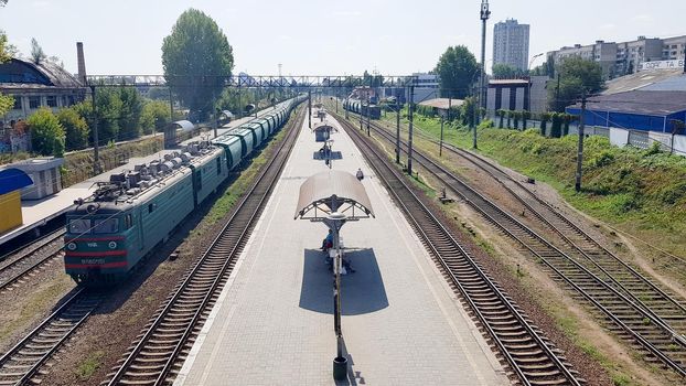 Ukraine, Kiev - June 16, 2019: Station with trains. The train stands at the railway station waiting for passengers in the daytime. Panorama, view from the bridge.