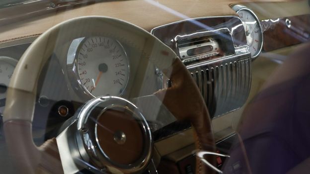 Salon, driver's seat with steering wheel, speedometer and radio tape recorder of a retro car, ZIL 41045 Soviet limousine. Executive class car. Ukraine, Kiev - June 04, 2021