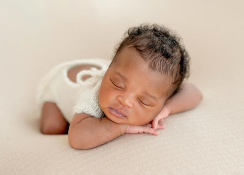 African newborn child resting lying on belly