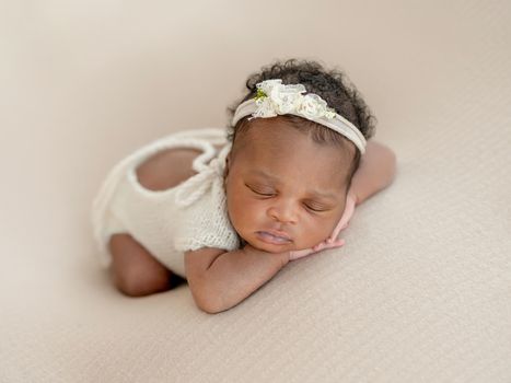 African newborn Baby girl dreams on her belly