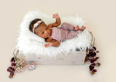 African newborn baby girl lying in cradle