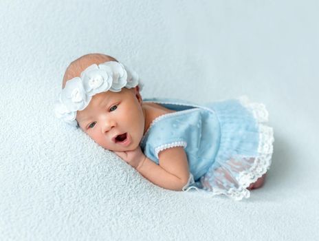 Cute newborn baby girl in a blue dress