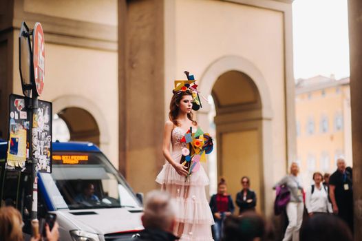 beautiful stylish girl model in a pink wedding dress photographed in Florence, holding an unusual bouquet, bride model with a bouquet in her hands, photo session of the bride in Florence