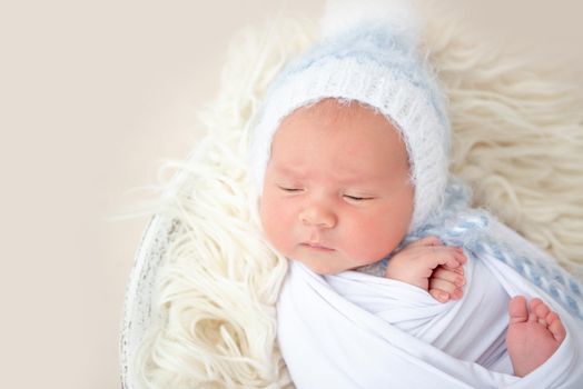 Charming wrapped up newborn lying awake