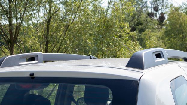 A station wagon roof rack for securing large loads or a cargo box. Travelling by car. Part installed on the roof of the vehicle