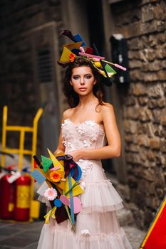 beautiful stylish girl model in a pink wedding dress photographed in Florence, holding an unusual bouquet, bride model with a bouquet in her hands, photo session of the bride in Florence