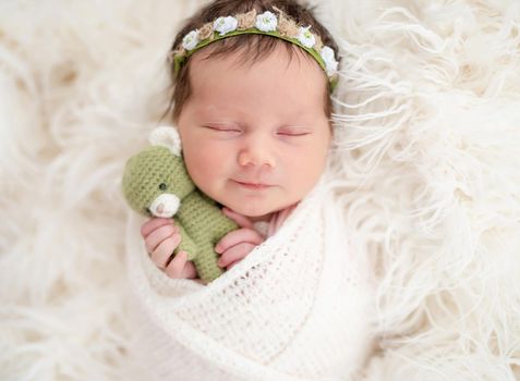 Adorable newborn smiling in dream