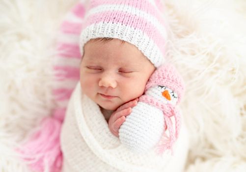Sweet newborn holding snowman toy