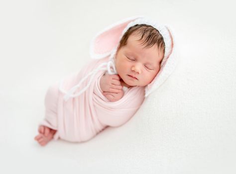 Funny newborn in knitted hat with ears