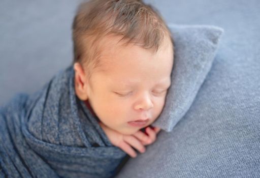 Sweet newborn sleeping on tiny pillow