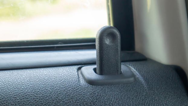 Close the lock button for the interior door of the vehicle. Door lock button inside the car interior close-up