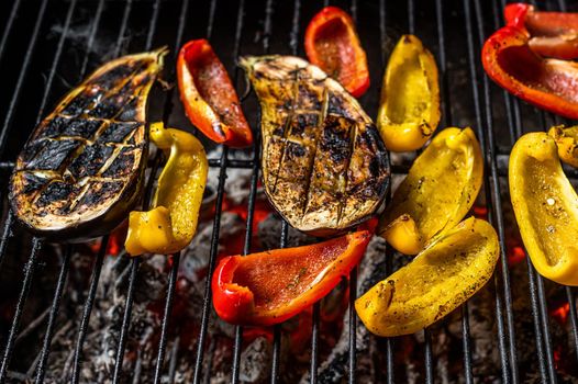 Grilled vegetables on barbecue, outdoor BBQ grill with fire. Top view.