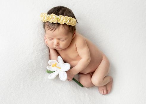 Just a few days old baby sleeping on tummy. Sleeping newborn child curled up. Beginning of a new life concept