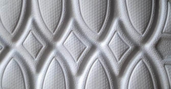 The outsole of new white sneakers. Rubber sole for men's shoes. Sole for sports and walking shoes. The texture of the material of sports shoes.
