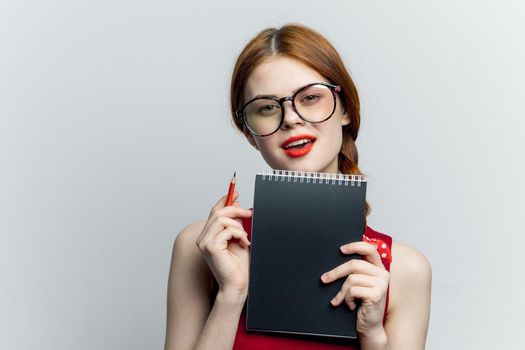 cheerful woman with glasses red dress notepad work. High quality photo