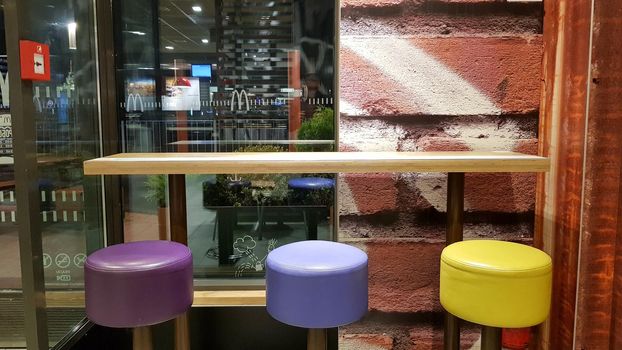 Ukraine, Kiev - August 19, 2019: McDonald's restaurant interior. McDonald's is the world's largest fast food restaurant chain based in the USA. Interior with tall tables and colored bar stools.