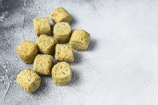 Raw falafel balls on a kitchen table. White background. Top view. Copy space.