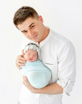 beautiful portrait of a young dad with his newborn daughter on white background