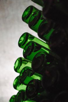 Green bottles of wine or champagne. Champagne production.