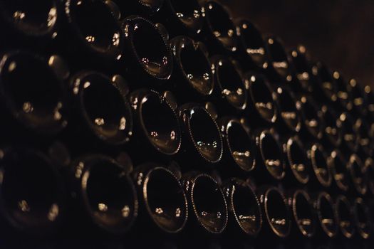 Green bottles of wine or champagne. Champagne production.