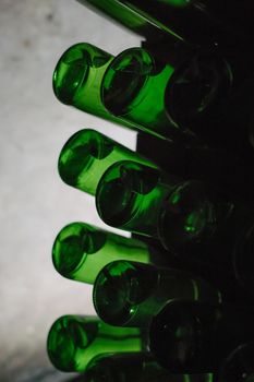 Green bottles of wine or champagne. Champagne production.