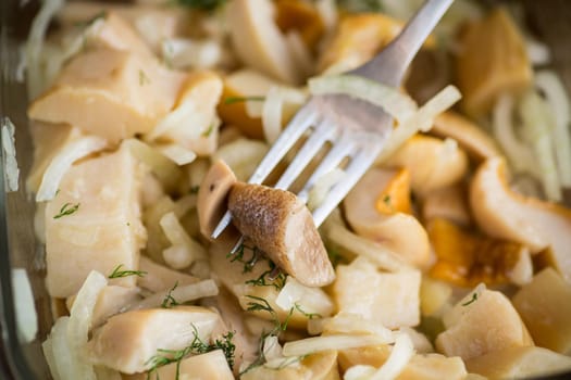 natural organic wild mushrooms marinated with onions in a glass bowl on the table