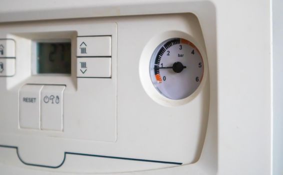 Internal control of a gas double-circuit boiler with a pressure and temperature sensor in the home heating system, close. Energy saving and image efficient home concept. Selective focus