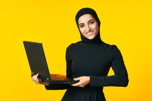 pretty woman arab clothing laptop technology internet ethnicity model. High quality photo