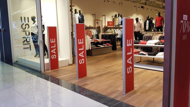 Ukraine, Kiev - September 04, 2019. Sale signs in a shop window in a shopping center on the day of shopping and the international holiday Black Friday, sale and discounts in clothing boutiques.