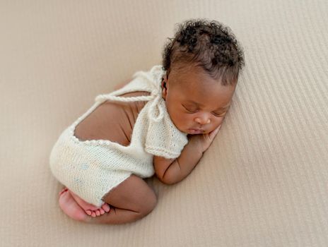 African newborn Sweet baby sleeps with crossed legs